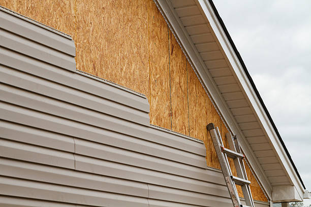 Professional Storm Damage Siding Repair technician working in White Hall, IL